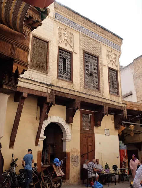 An ochre house and small public square in the medina of Fes.