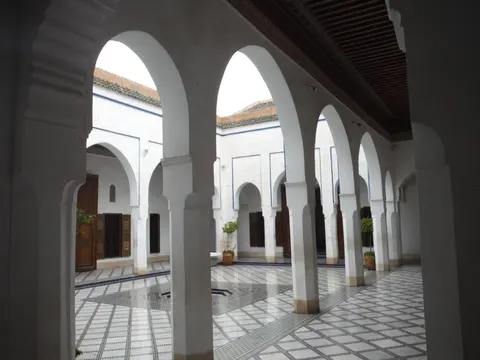 A broad tiled courtyard and decorated arcades at Bahia Palace in Marrakech.