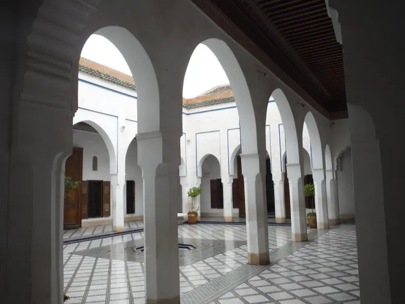 A broad tiled courtyard and decorated arcades at Bahia Palace in Marrakech.